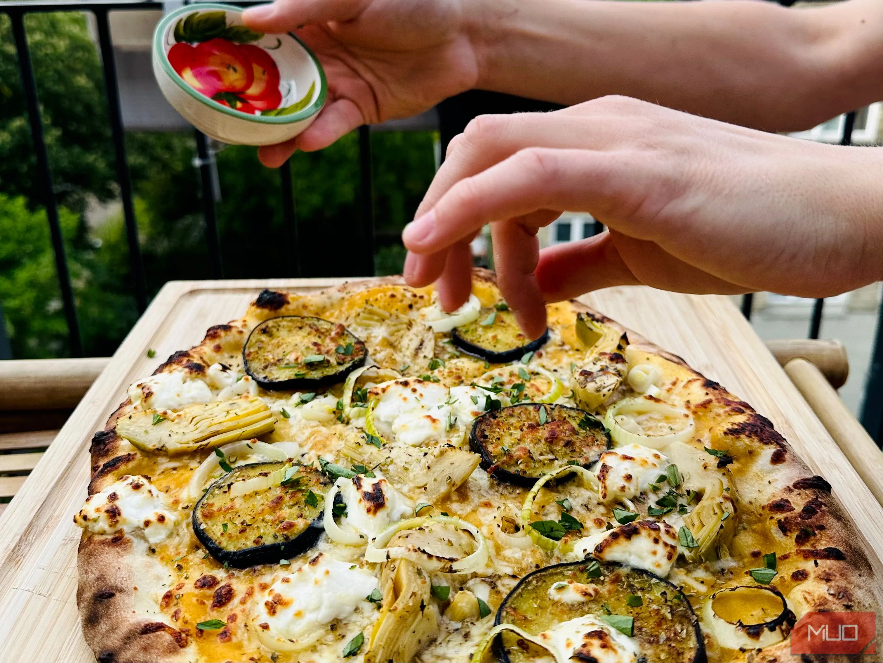 Ảnh chụp cảnh làm pizza tại nhà cùng bạn bè, ghi lại khoảnh khắc vui vẻ và ẩm thực.