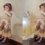 Bé gái ôm búp bê trong ảnh cũ được AI Picsart làm rõ nét