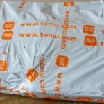 Gói hàng Temu trên bàn, liên quan đến thông báo tăng giá