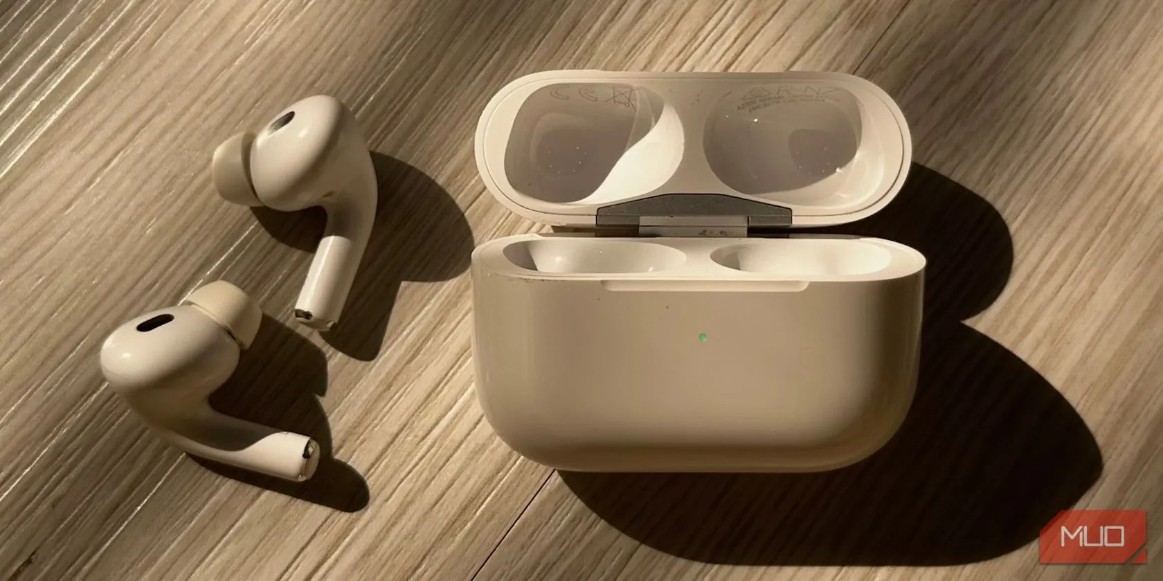 Hộp sạc AirPods hiển thị đèn trạng thái màu xanh lá cây, đặc trưng của các mẫu AirPods 3 hoặc AirPods Pro