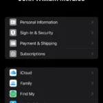 Màn hình cài đặt hồ sơ Apple ID trên iPhone hiển thị thông tin tài khoản chính và tùy chọn Media & Purchases để quản lý tài khoản phụ.