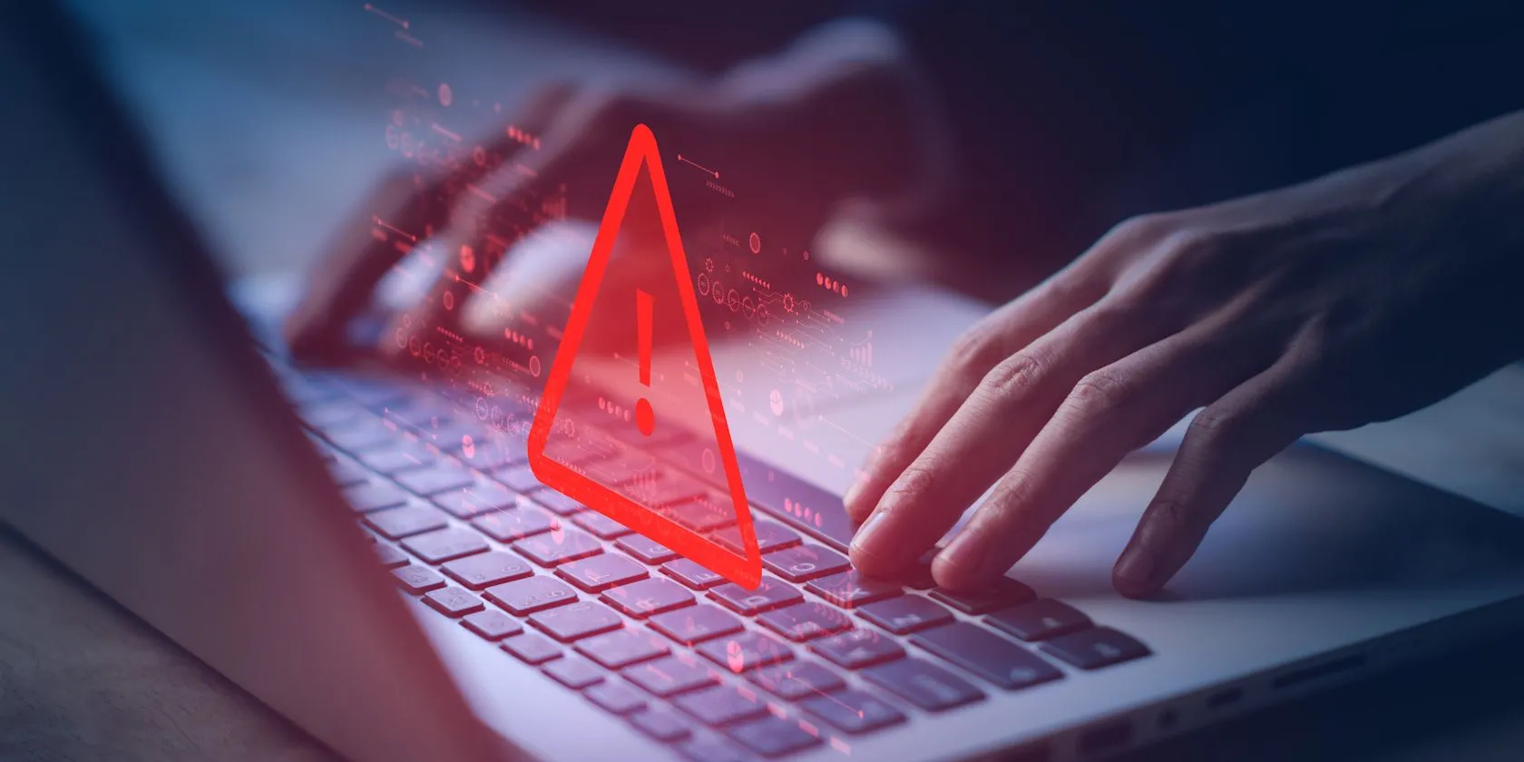 Một người đang sử dụng máy tính xách tay với cảnh báo bảo mật, minh họa rủi ro khi hacker cố gắng đoán các câu hỏi bảo mật phổ biến.