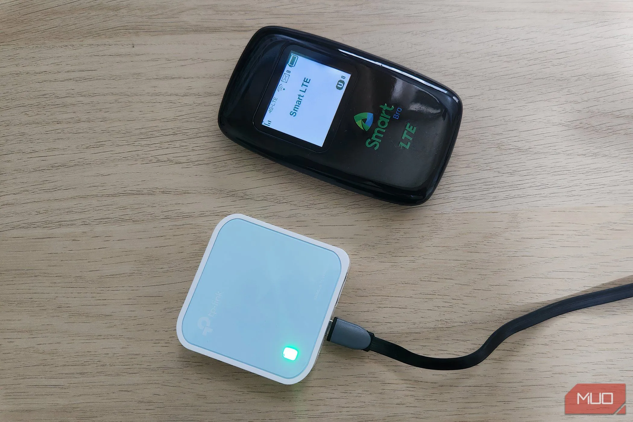 Thiết bị phát Wi-Fi di động và router du lịch nhỏ gọn đặt trên bàn làm việc.